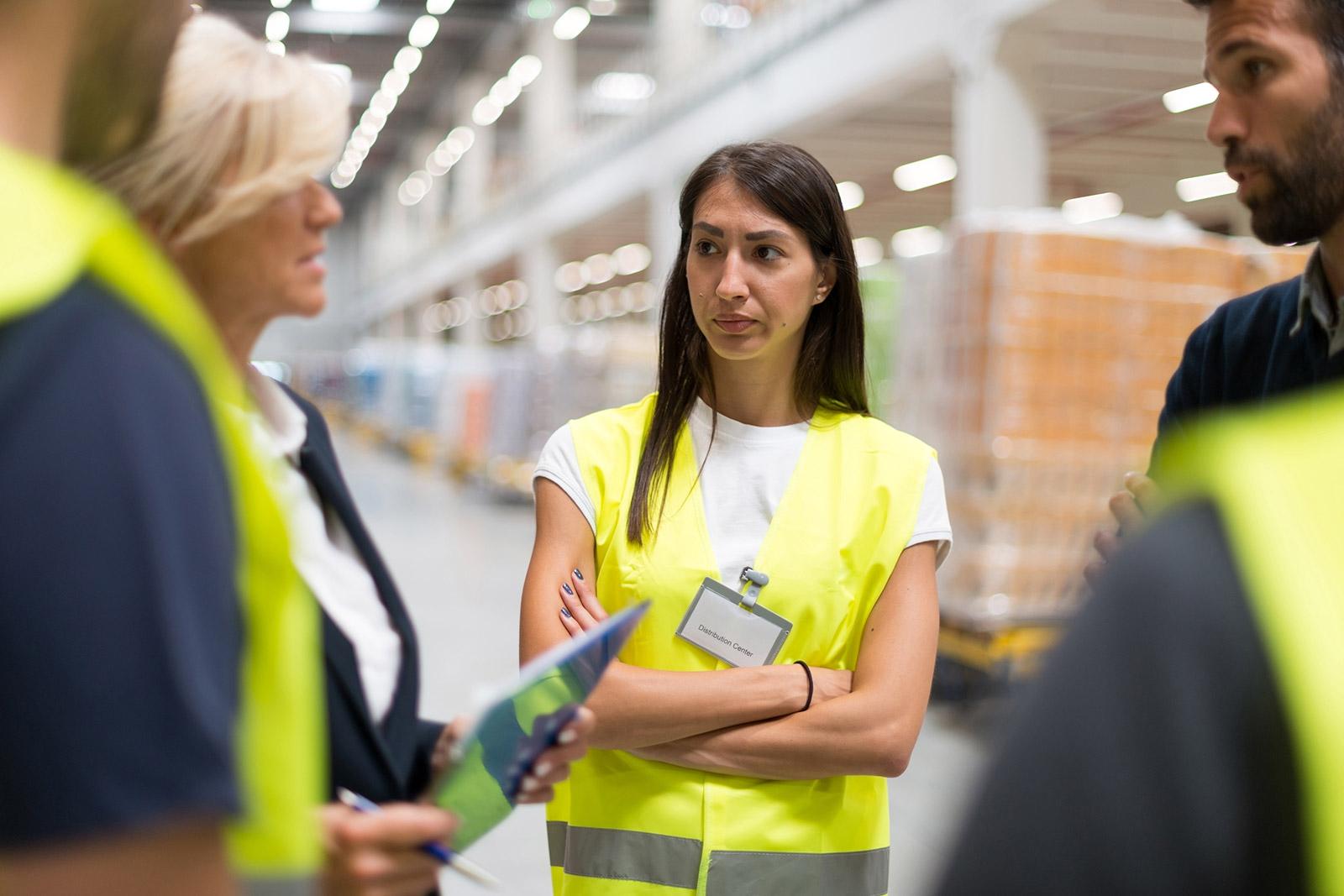 bodega con cajas de mercancia, mujer mayor dirigiendo el trabajo